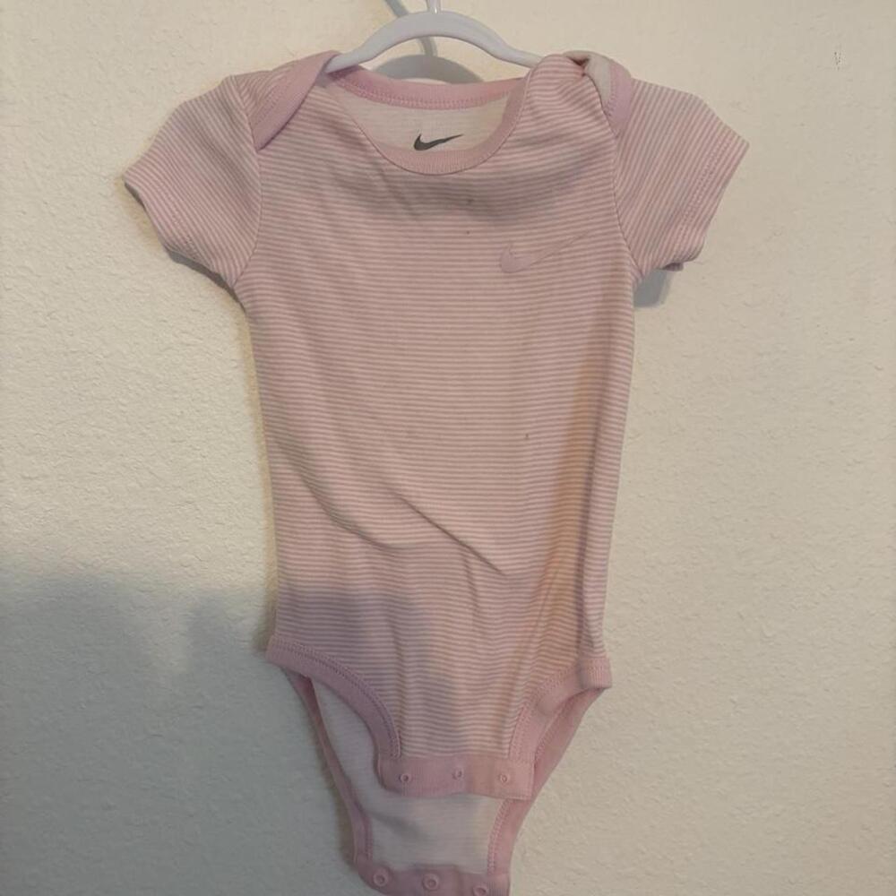Nike baby bodysuit in pink with thin white horizontal stripes, size 0M. Cotton &